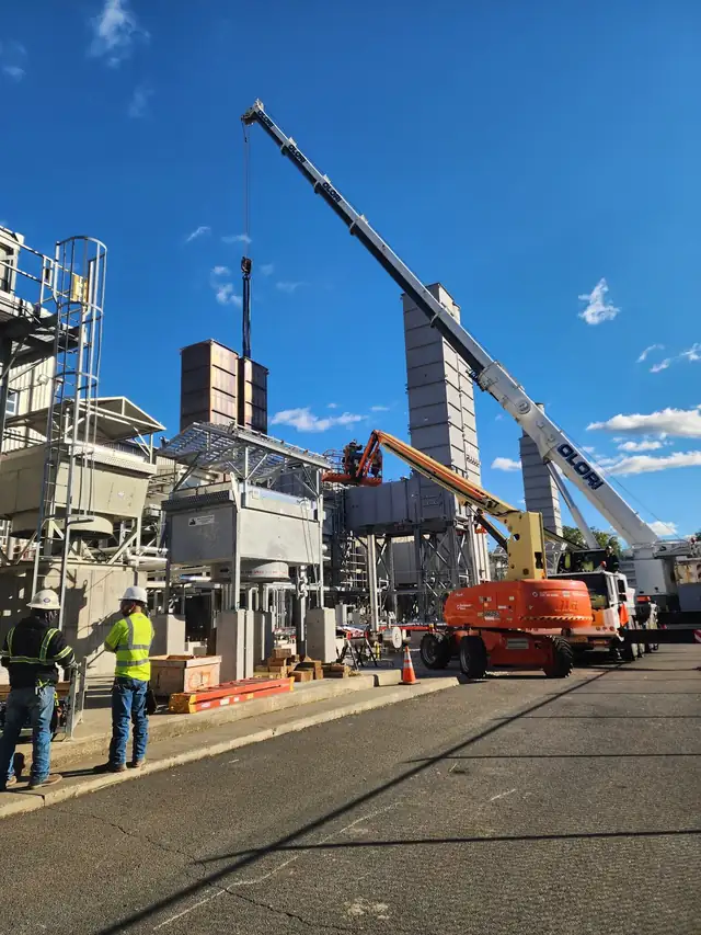 Crane and lift crew working at a natural gas compressor station